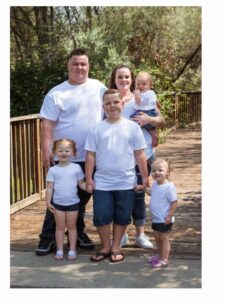 Crystal with her family outdoors